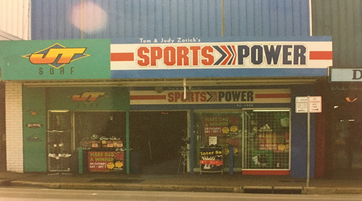 Vintage 'Sports Power' store front with prominent signage.